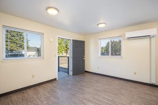 A room with a door and two windows.