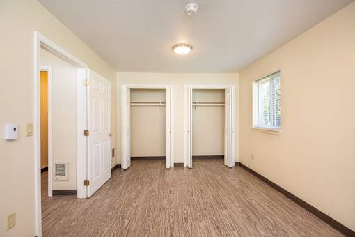 A room with a light brown floor and white walls.