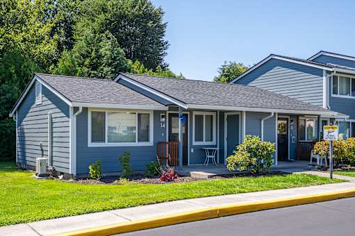 A blue house with a yellow caution sign in front.