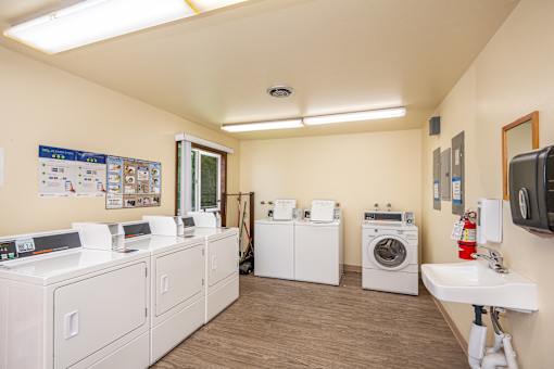 A laundry room with washers and dryers.