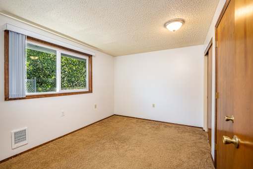 A room with a window and a door.