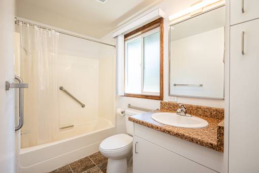 A white toilet sits next to a sink in a bathroom.