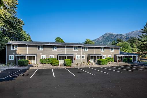 A large building with a parking lot in front of it.