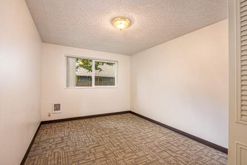the living room of an empty house with a window