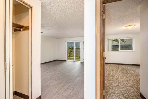 the living room and dining room of an empty house