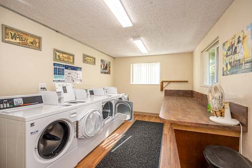 a laundry room with washing machines and a counter with a washer and dryer