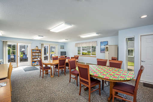 A room with a table and chairs in it.