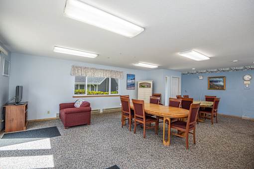 A room with a table and chairs in it.