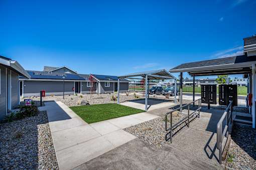 A sunny day at a residential area with houses and a clear blue sky.