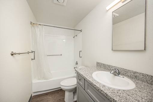 A white toilet sits next to a sink in a bathroom.