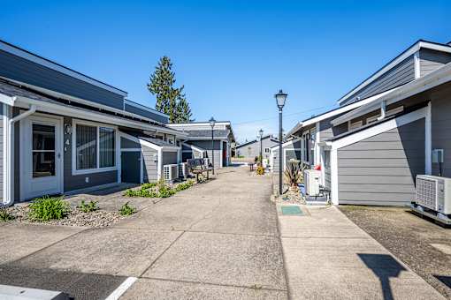 A row of houses with a clear blue sky above them.