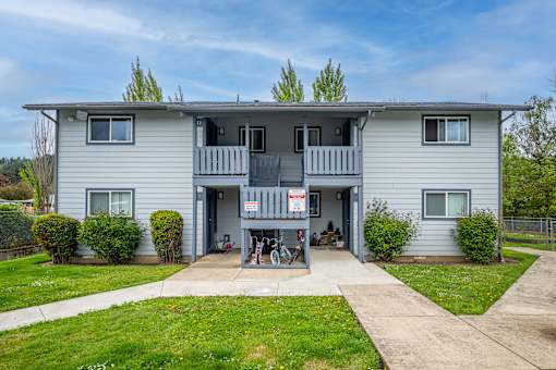 A two-story house with a balcony on the second floor.