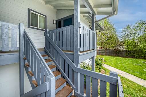 A house with a grey staircase and a grey railing.
