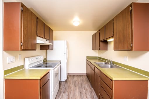 a kitchen with wooden cabinets and white appliances