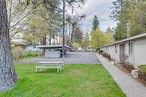 A park with a bench and a pathway.