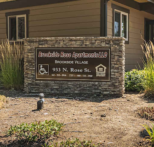 a sign apartments on the front of a building