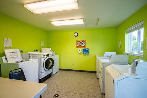 A laundry room with washers and dryers.