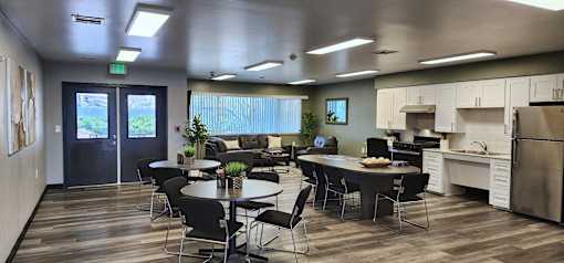 A modern kitchen with a dining table and chairs.
