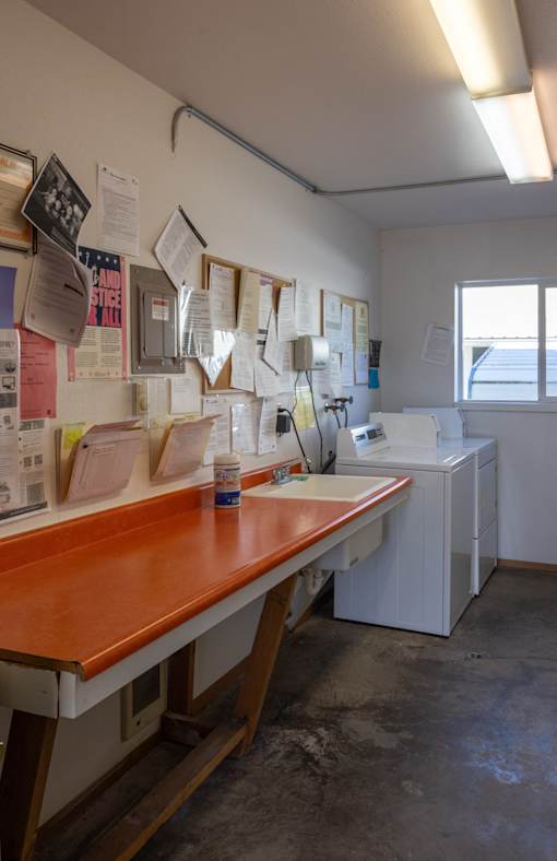 a counter in a room with papers on the wall and a counter top in front