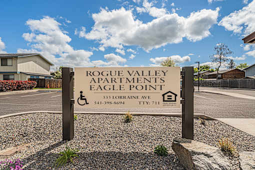 a sign for rogue valley apartments eagle point