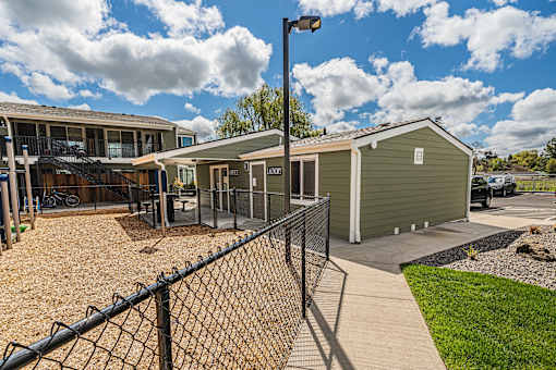 a building with a fenced in yard and a fence