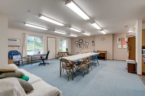 a multipurpose room with a table and chairs and a couch