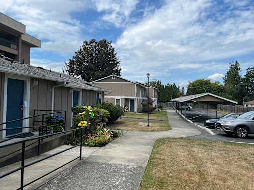 A residential area with houses and parked cars.