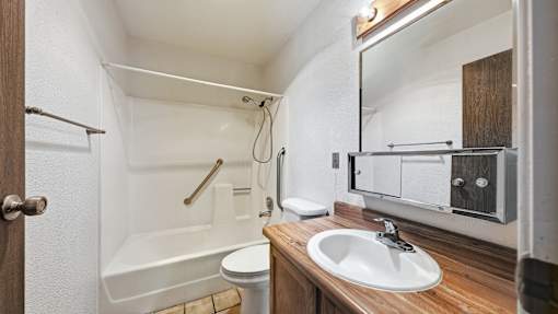 A small bathroom with a toilet, sink, and bathtub.