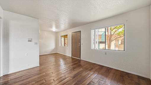 A room with wooden floors and white walls.