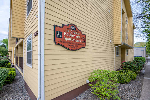 A building with a sign that says La Retirement Apartments.