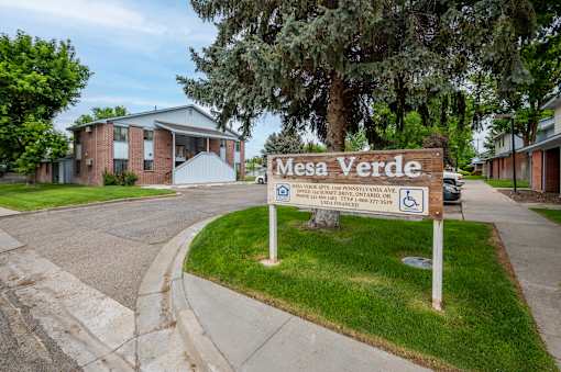 A sign for Mesa Verde in front of a building.