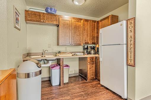 a small kitchen with a refrigerator and a sink