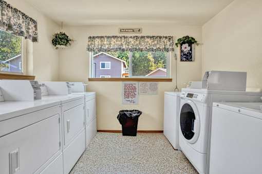 a washer and dryer in a laundry room with a window