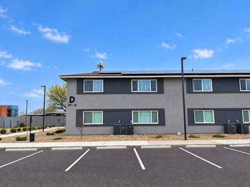 A grey building with a sign that says D on it.