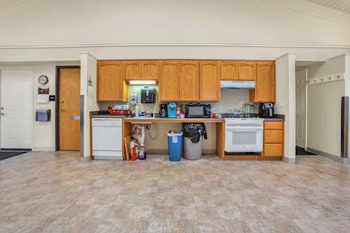 a kitchen with wood cabinets and a white stove and a sink