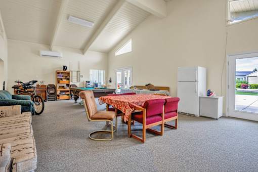 a large living room with a table and chairs
