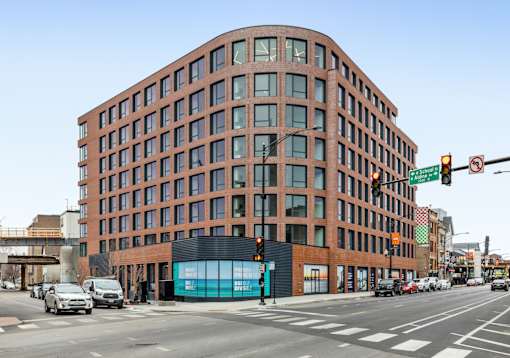 a tall brick building on the corner of a city street