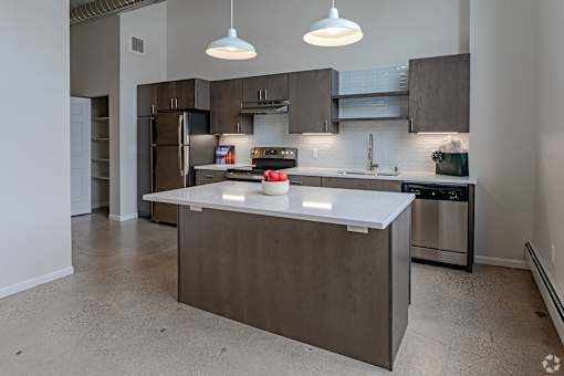 A modern kitchen with a large island in the center.