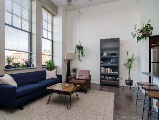 a living room with a blue couch and a table