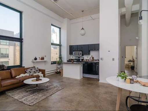 a living room with a couch and a kitchen