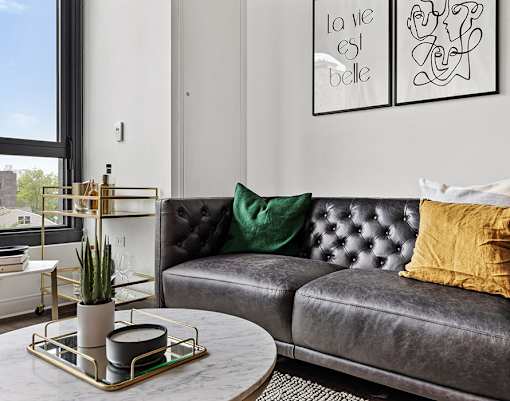 a living room with a leather couch and a coffee table