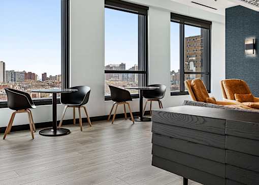 a living room with a table and chairs and a large window