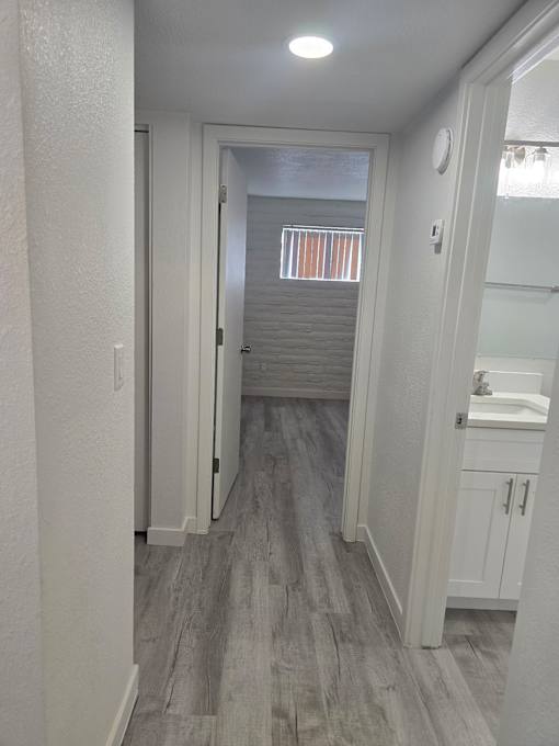A bathroom with a white sink and a white cabinet.