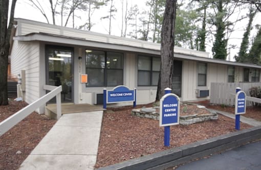 A building with a sign that says Welcome Center Parking.