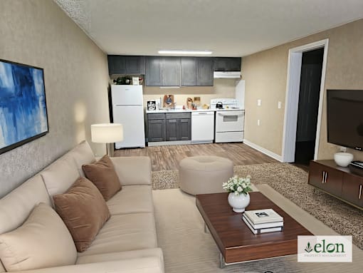 A modern living room with a couch, coffee table, and a kitchen in the background.