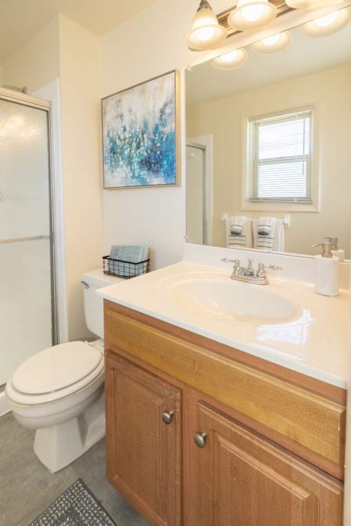 Bathroom with toilet and sink with cabinets