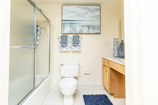 A bathroom with a toilet, sink, and shower.