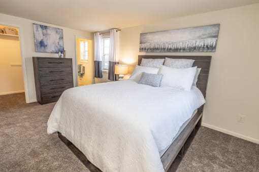 a bedroom with a large bed and a dresser at Chapel Valley Townhomes, Baltimore