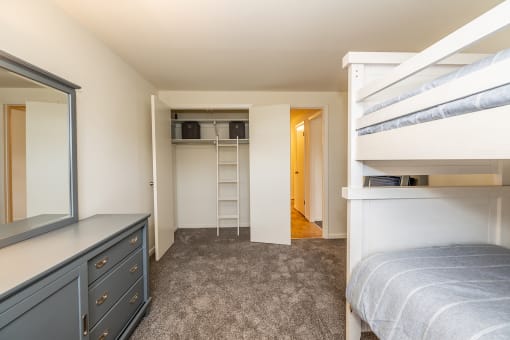 a bedroom with bunk beds and a dresser at Chapel Valley Townhomes, Baltimore, MD