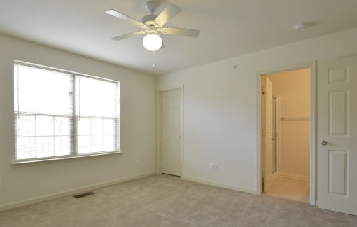 Bedroom with a ceiling fan and a window at The Pointe at Manorgreen Townhomes, Maryland, 21220